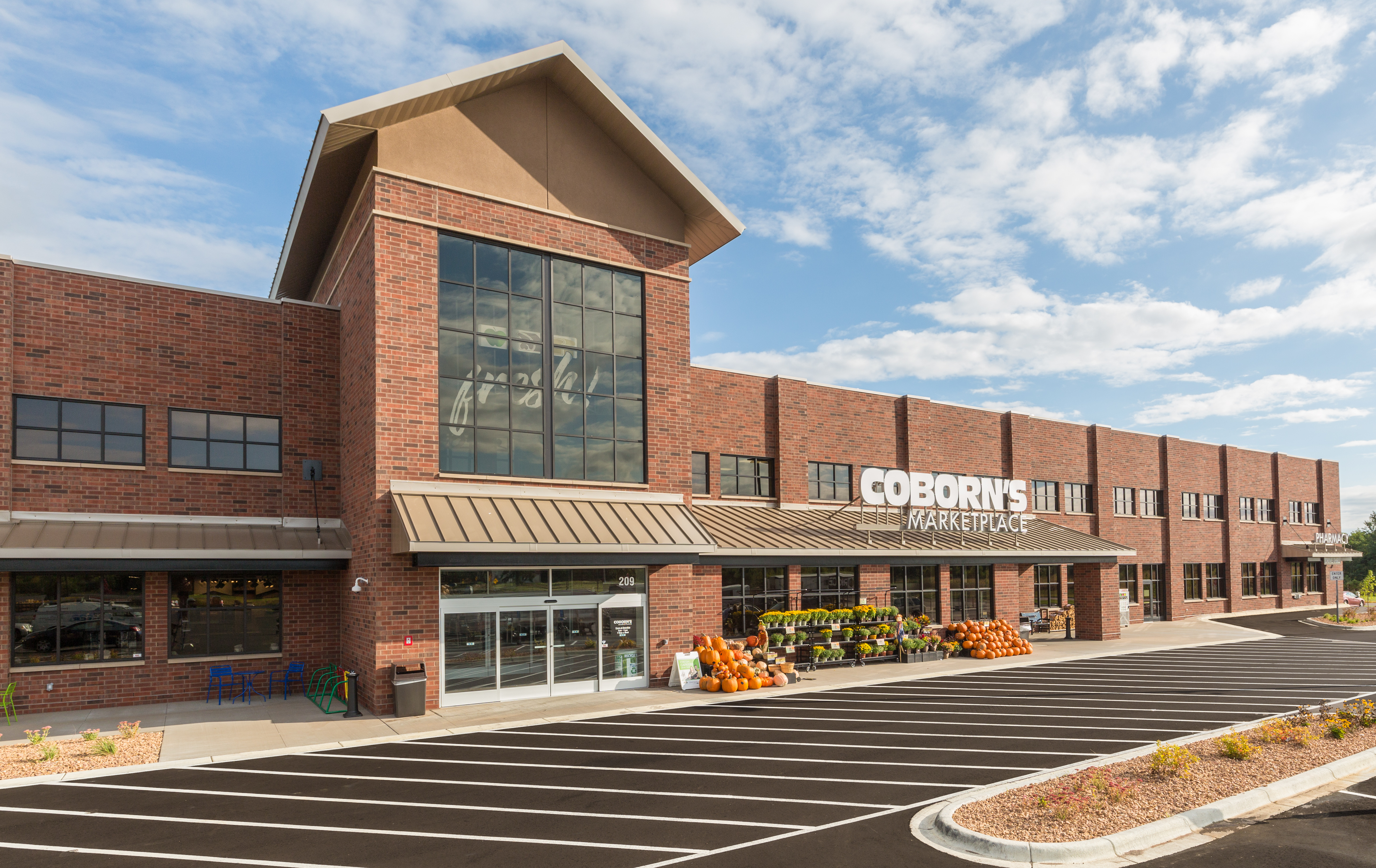 Coborn’s Marketplace grocery store with brick façade, large windows, and metal roof canopy.